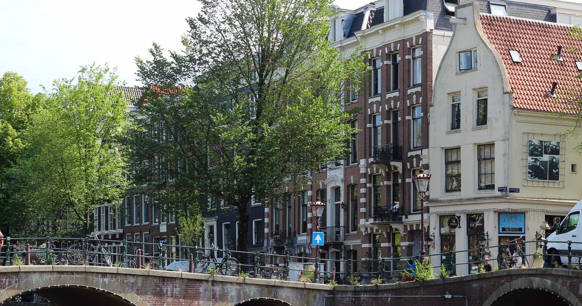 Historic brick houses and a canal bridge in Amsterdam, Netherlands
