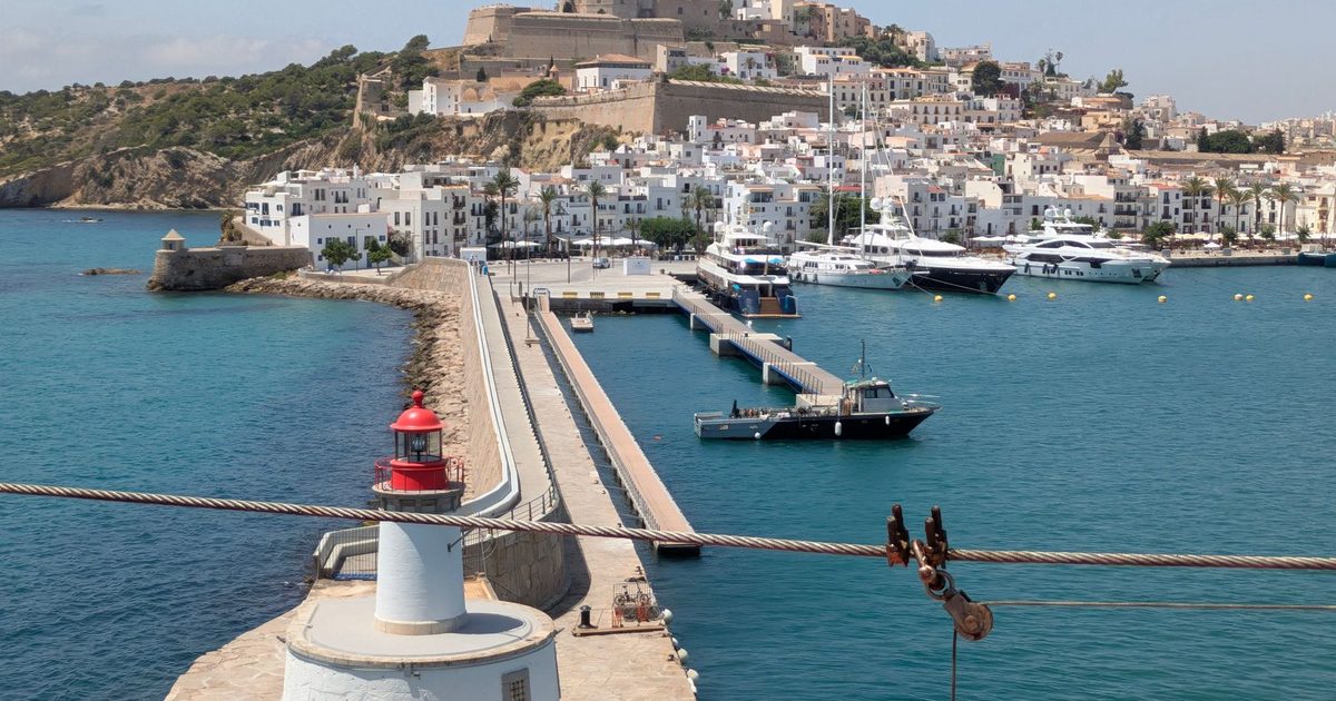 Ibiza harbour, with a lighthouse and the old town behind