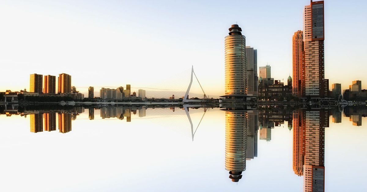 The Rotterdam skyline reflected in the water at dusk
